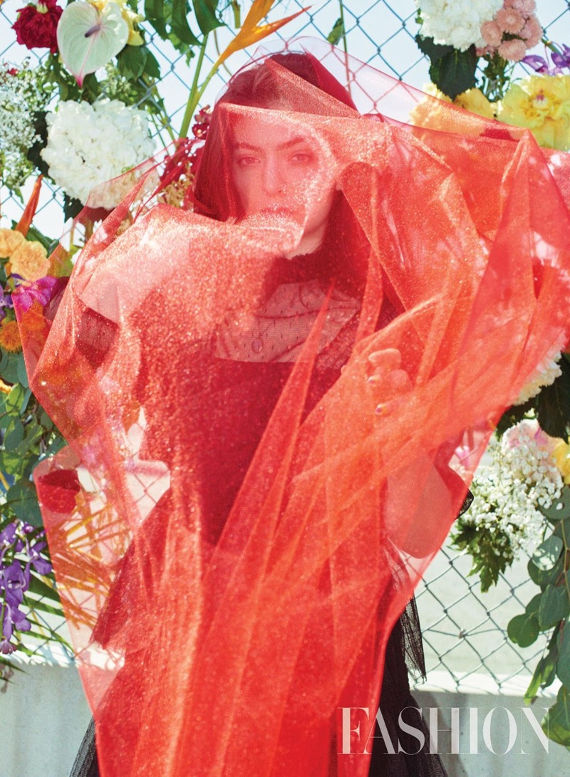 Lorde poses in a Red Valentino dress