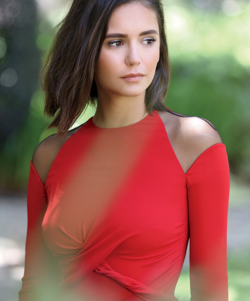 Nina Dobrev poses in red Versace open shoulder dress
