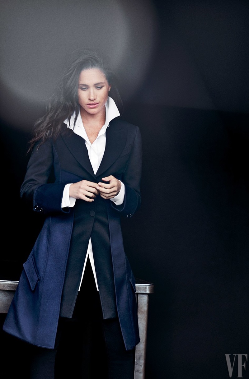 Actress Meghan Markle poses in navy coat