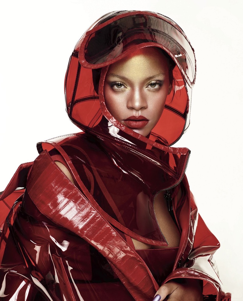 Wearing red lipstick, Rihanna poses in Dolce & Gabbana helmet and PVC coat