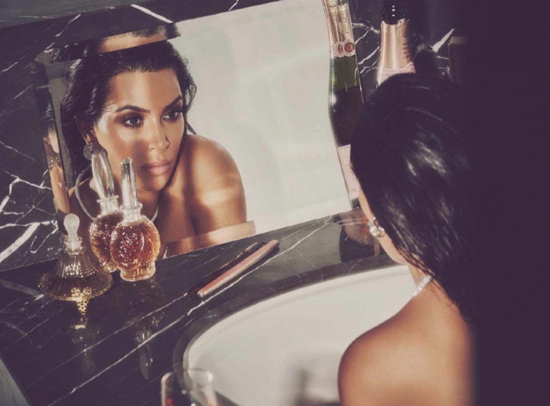 Looking in the mirror, Kim Kardashian wears Cartier jewelry