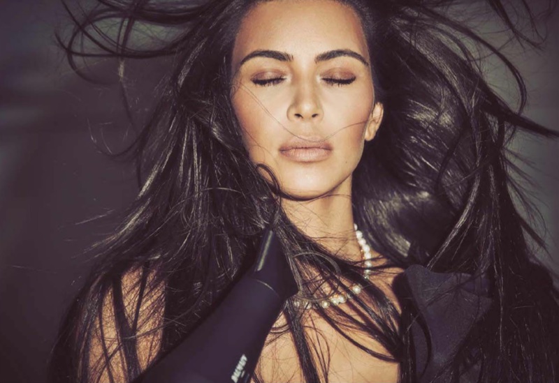 Posing with a blowdryer, Kim Kardashian wears Johanna Ortiz dress and Mordekai choker necklace