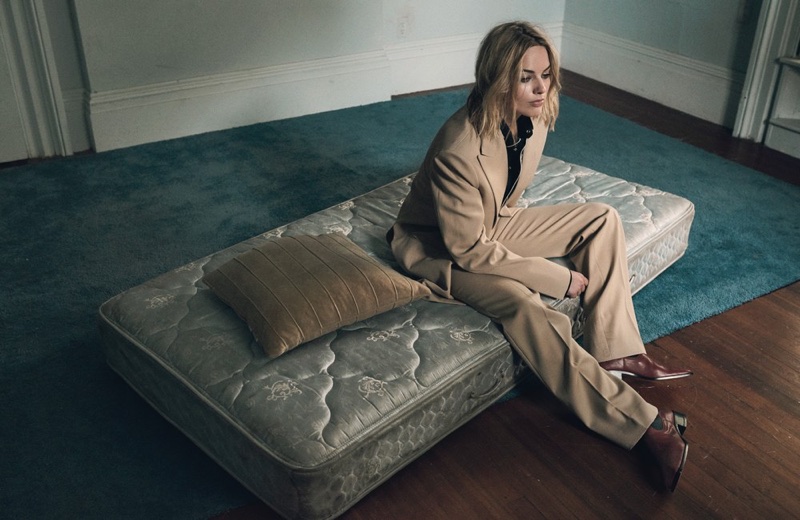 Posing on a mattress, Margot Robbie wears Celine jacket, pants and boots with Linder shirt