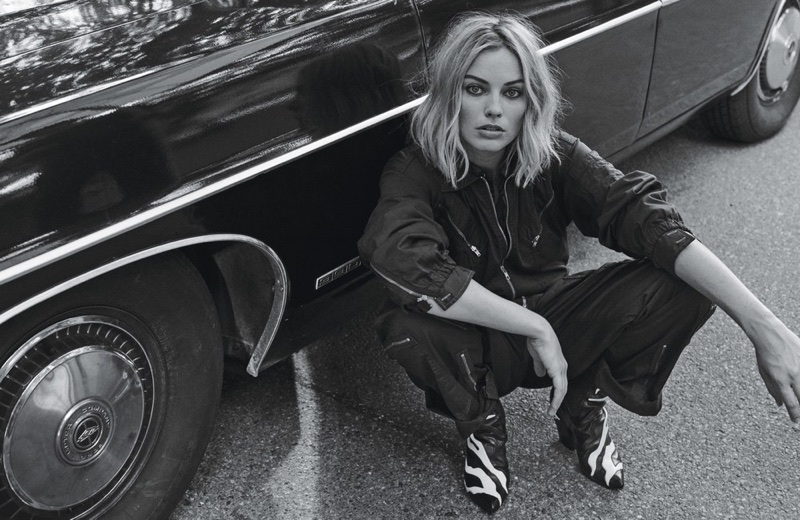 Photographed in black and white, Margot Robbie wears Nili Lotan jumpsuit, Gucci shirt and Louis Vuitton boots