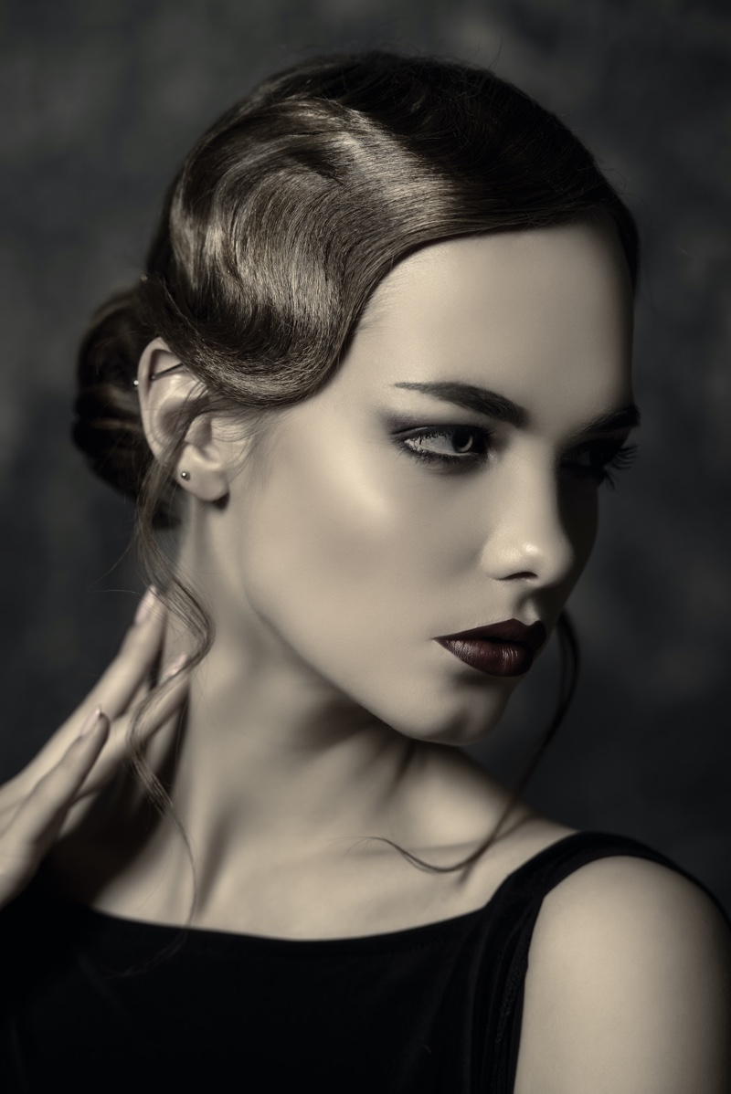 This sleek updo hairstyle features a wavy front for a 1920s look made modern.