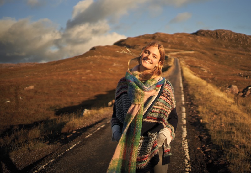 Model Constance Jablonski layers up in knit scarf and striped sweater for Anthropologie’s November 2017 catalog