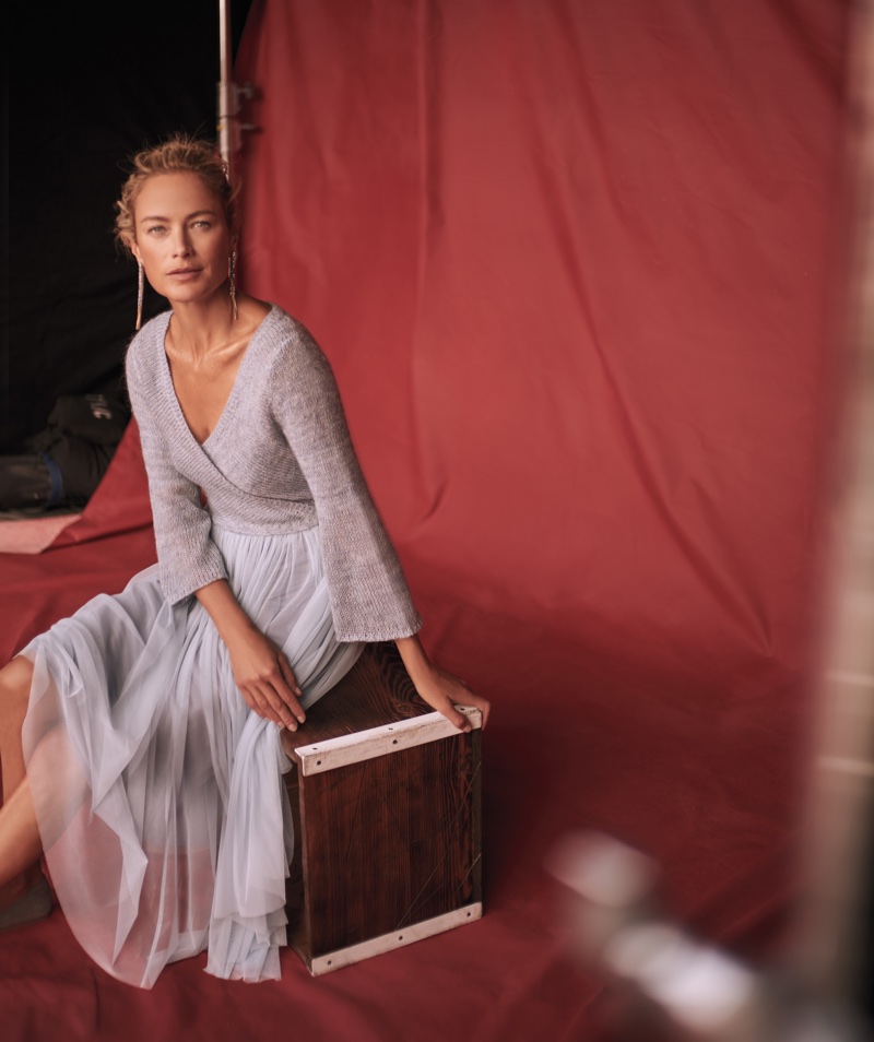 Carolyn Murphy poses in wrap top and pleated skirt for Anthropologie’s November 2017 catalog