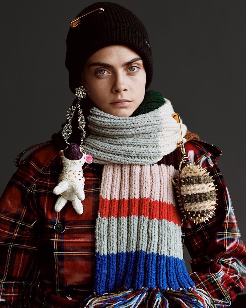 Layering up, Cara Delevingne wears Burberry tartan trench coat and multicolored scarf