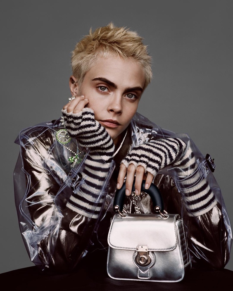 Model Cara Delevingne wears PVC coat and The DK88 bag in Burberry’s Holiday 2017 campaign