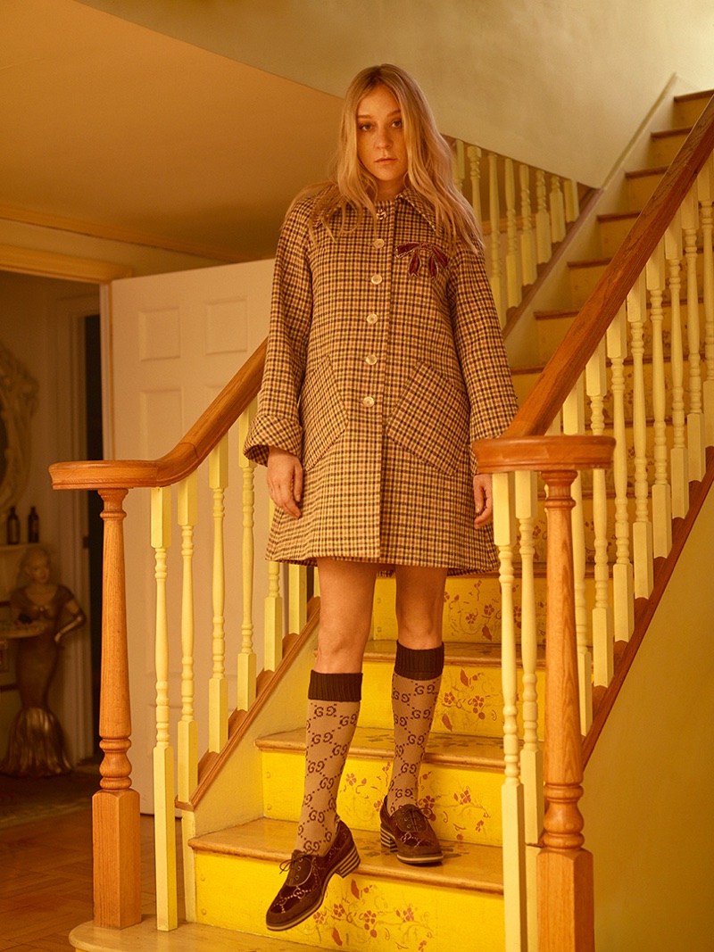 Chloe Sevigny wears checkered coat, socks and loafers from Gucci