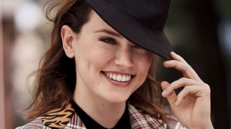 Flashing a smile, Daisy Ridley wears John Galliano coat, Sunday Best for Aritizia dress and East Village Hats fedora