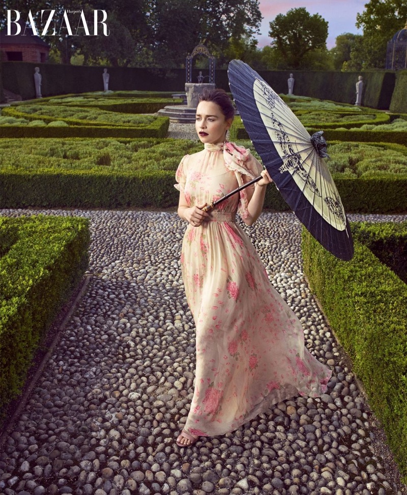 Actress Emilia Clarke poses in Valentino gown, Gianvito Rossi sandals and Gucci umbrella