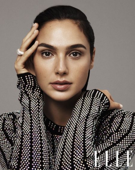 Gal Gadot Poses in Sleek Fashions for ELLE Cover Story Getting her closeup, Gal Gadot wears Gucci crystal embellished top and Cartier ring