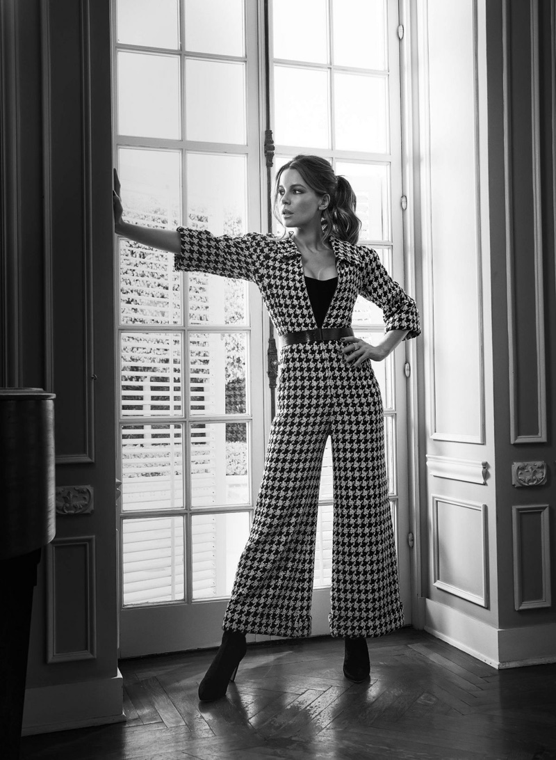 Striking a pose, Kate Beckinsale wears Chanel jumpsuit and Jimmy Choo boots