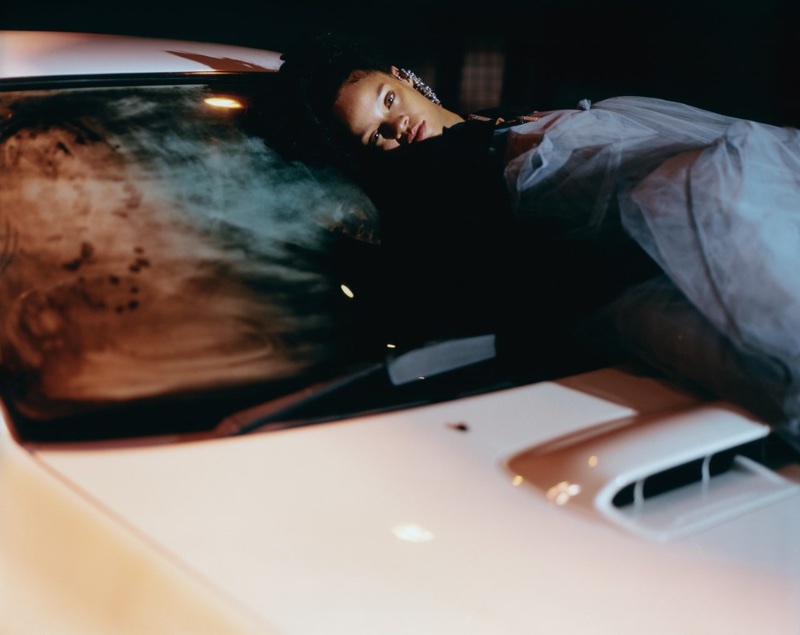 Lounging on a car, Rihanna wears Unravel bolero bomber jacket, Molly Goddard tulle dress and Mulberry earrings