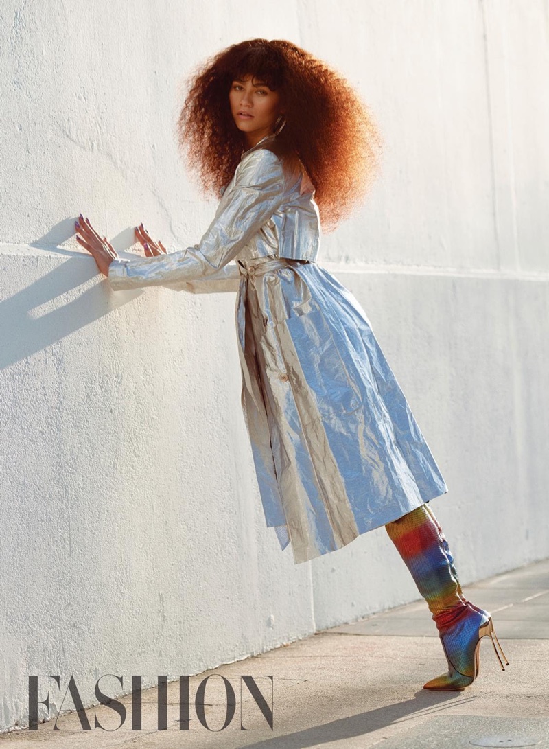 Wearing a Sally LaPointe coat, Zendaya poses outdoors in Casadei rainbow boots and Jennifer Fisher earrings