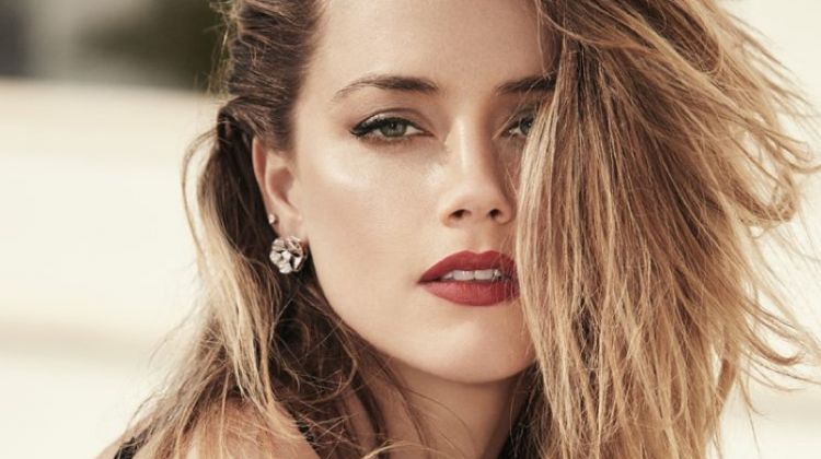 Showing off a tousled hairstyle, Amber Heard poses in lingerie