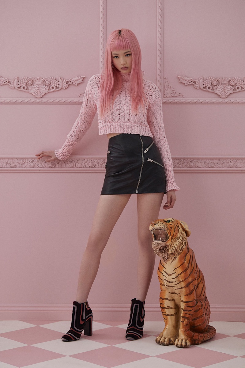 Looking pretty in pink, Fernanda Ly wears cropped pink sweater from For Love & Lemons Knitz