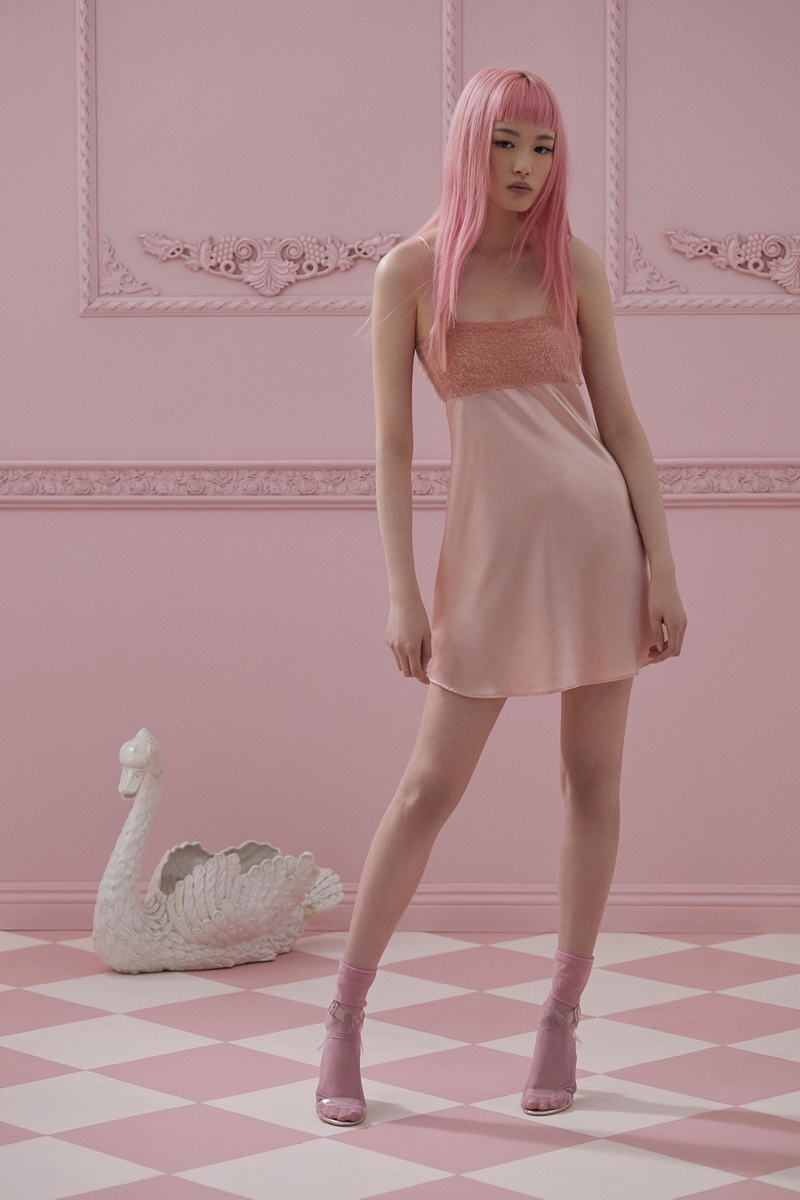 Fernanda Ly poses in pink mini dress from For Love & Lemons Knitz