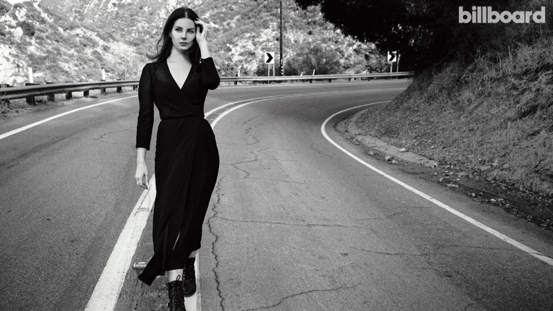 Walking on an empty road, Lana Del Rey wears black dress