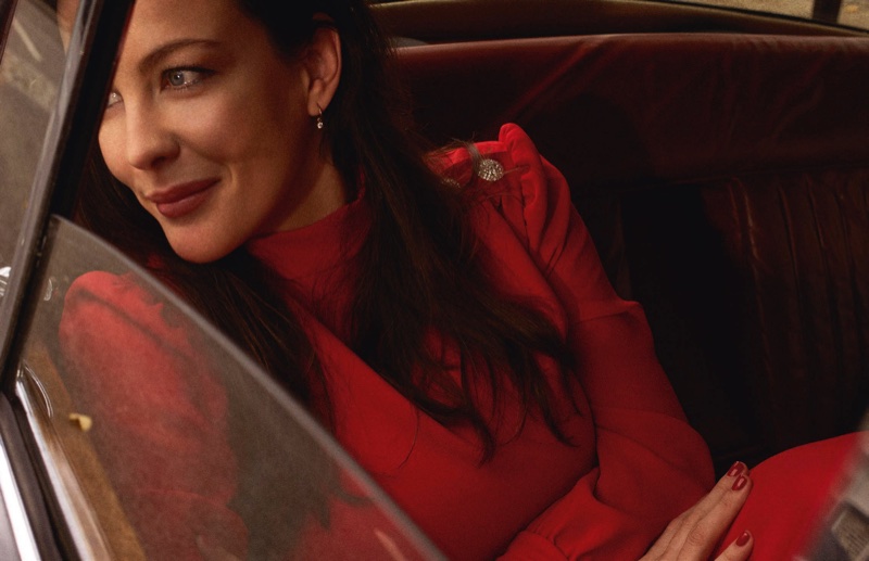 Liv Tyler flashes a smile in a red dress