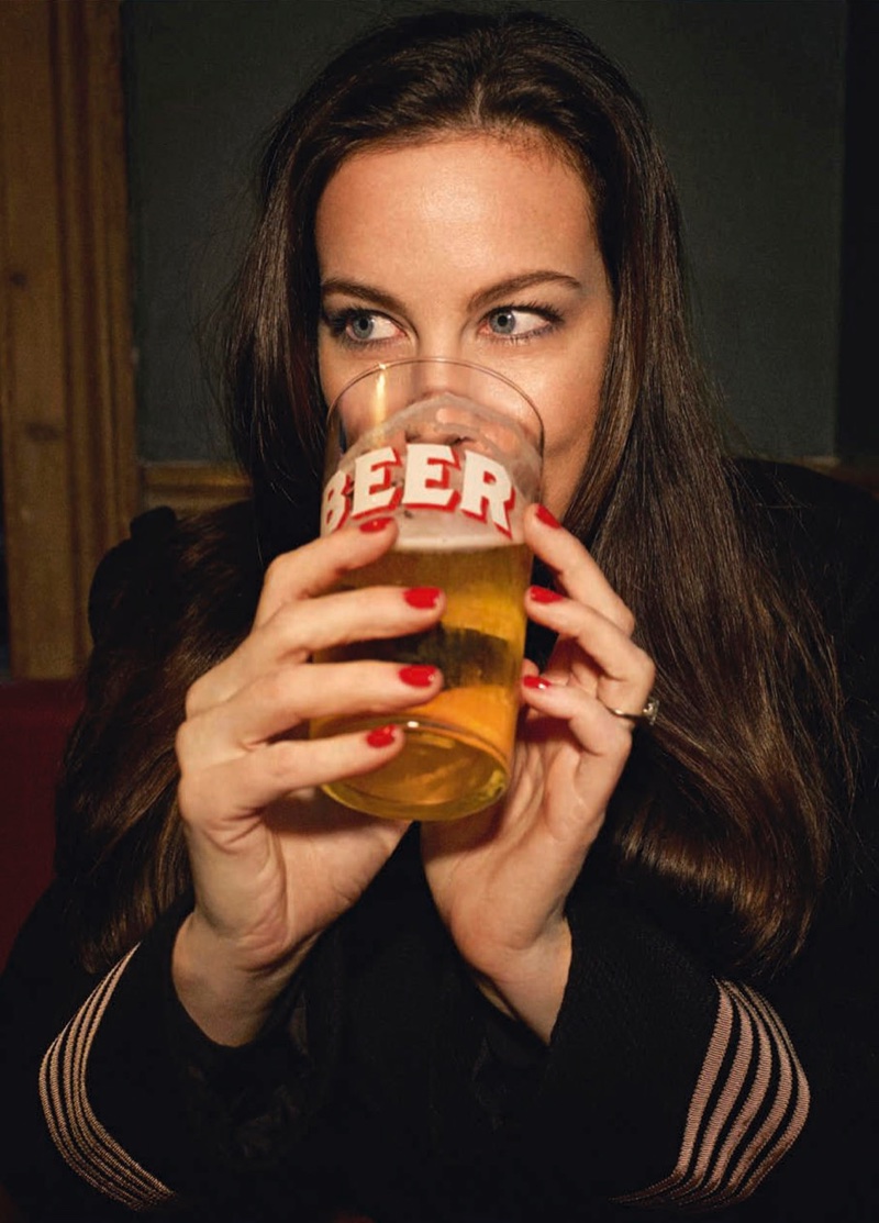 Taking a drink of beer, Liv Tyler shows off a red manicure