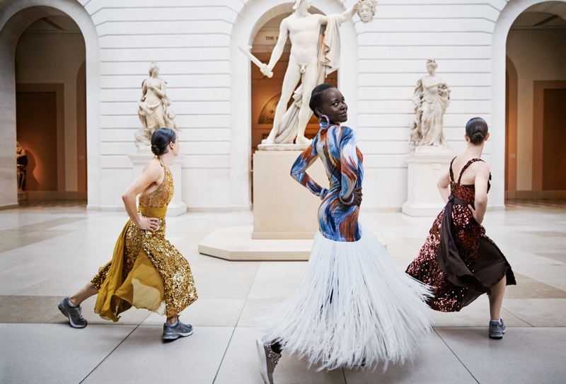 Dancing, Lupita Nyong’o poses in Celine dress, Atelier Swarovski by Christopher Kane bracelets and Giuseppe Zanotti sneakers