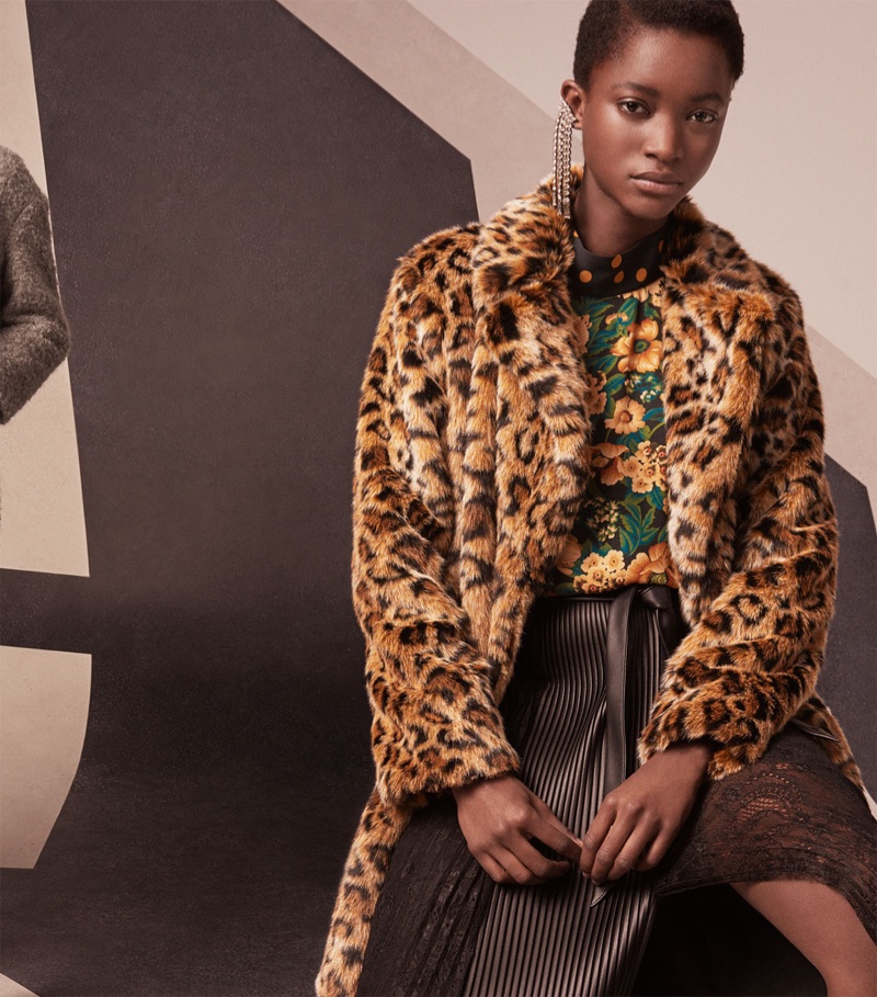 Oumie Jammeh models Zara faux fur leopard print coat, floral and polka dot print top and combined pleated skirt