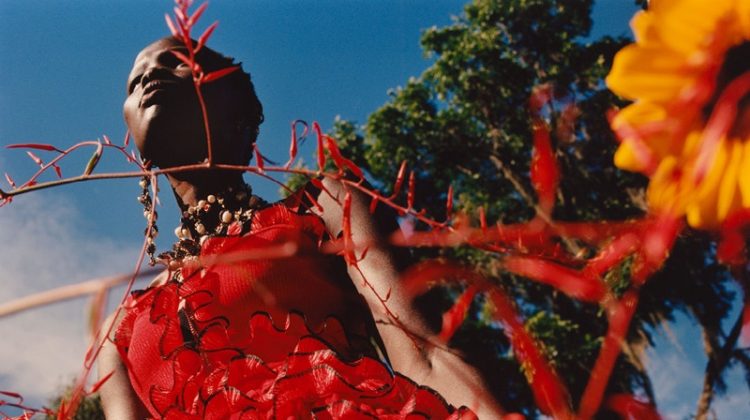 Model Shanelle Nyasiase poses in red dress for Alexander McQueen's spring-summer 2018 campaign