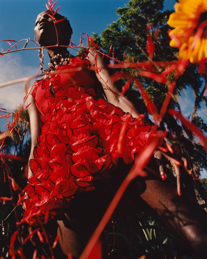 Model Shanelle Nyasiase poses in red dress for Alexander McQueen's spring-summer 2018 campaign