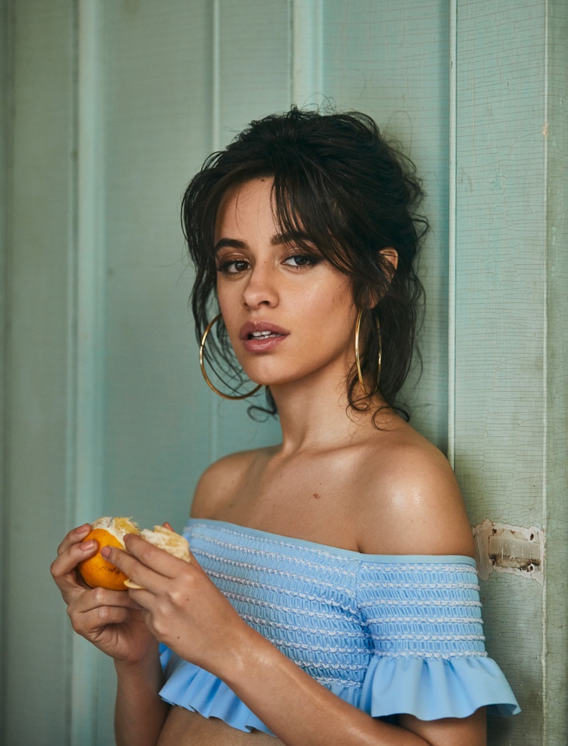 Flaunting some shoulder, Camila Cabello poses in Jonathan Simkhai top and Jennifer Fisher earrings