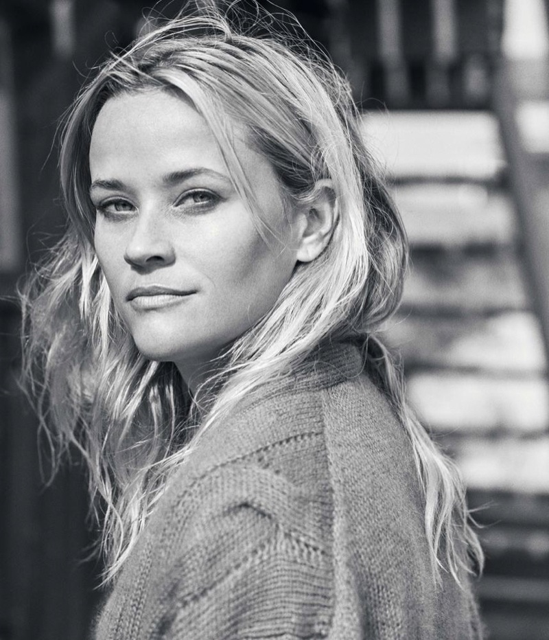 Photographed in black and white, Reese Witherspoon poses in a Gucci sweater