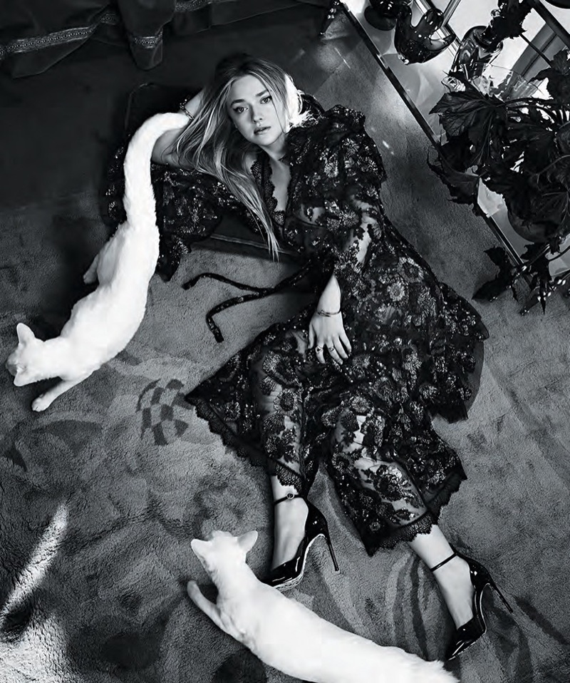 Photographed in black and white, Dakota Fanning wears embroidered gown