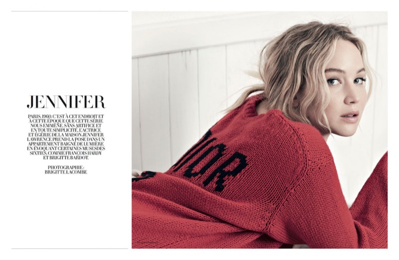 Actress Jennifer Lawrence poses in red Dior sweater