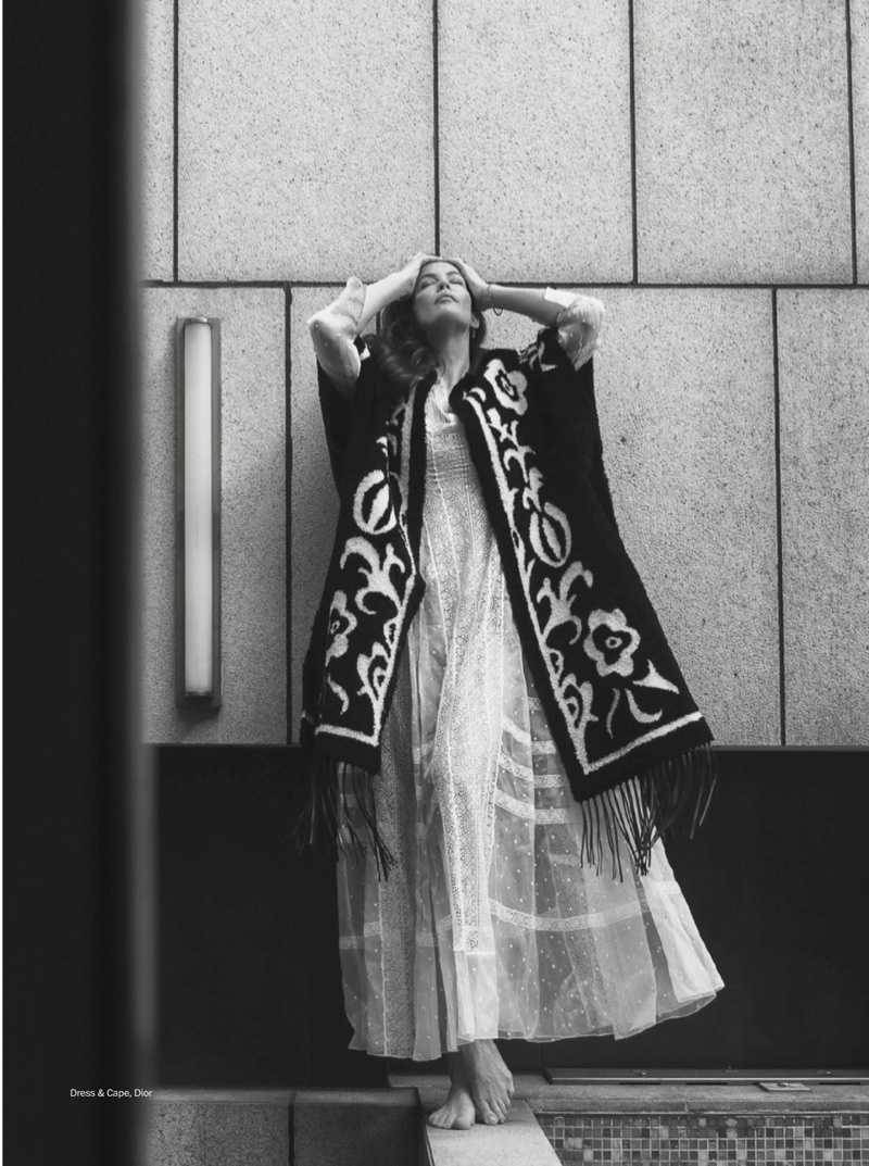 Photographed in black and white, Liv Tyler wears Dior cape and dress