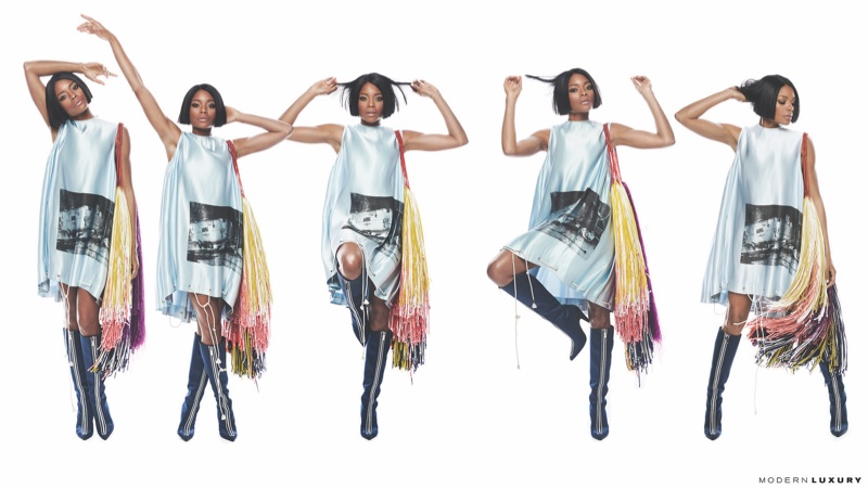 Actress Naomie Harris poses in Calvin Klein minidress and boots