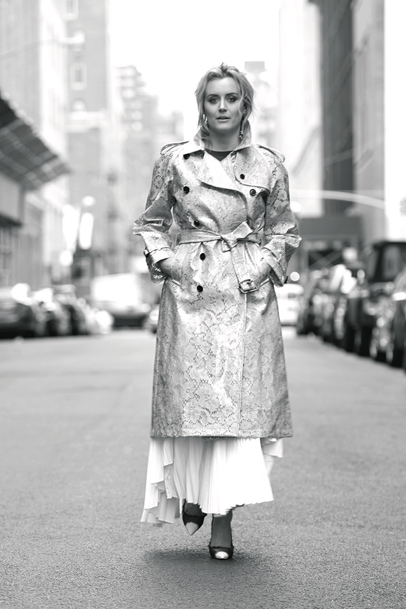 Photographed in black and white, Taylor Schilling wears Burberry coat