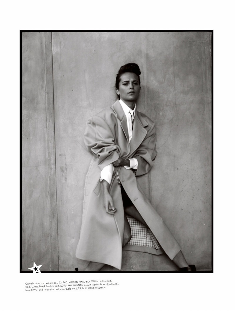 Actress Alicia Vikander wears Maison Margiela coat, Gant shirt and The Kooples skirt