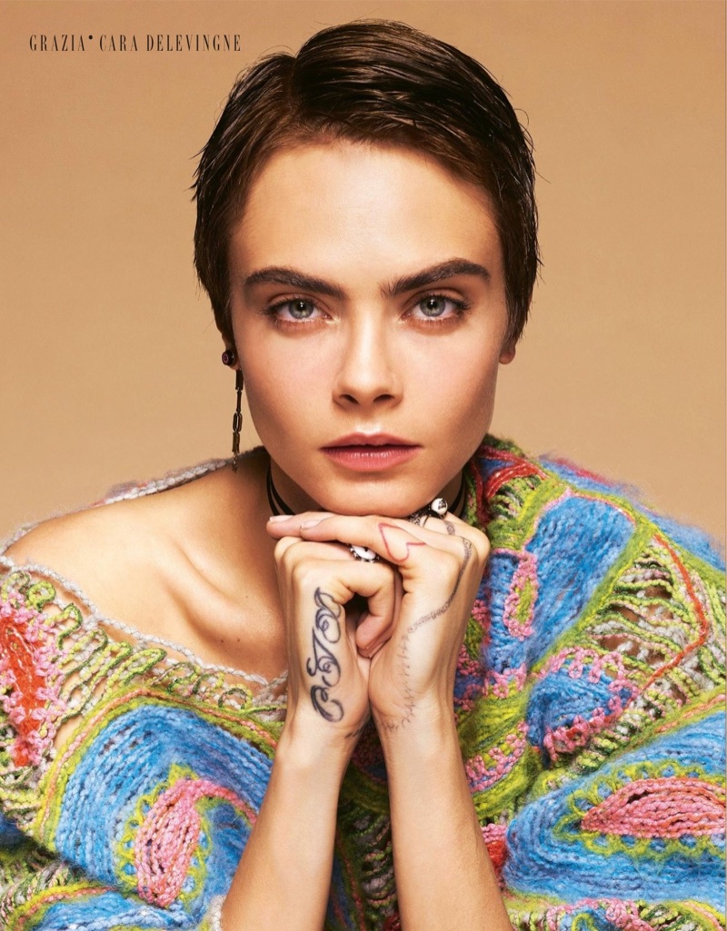 Model Cara Delevingne shows off a brown pixie haircut