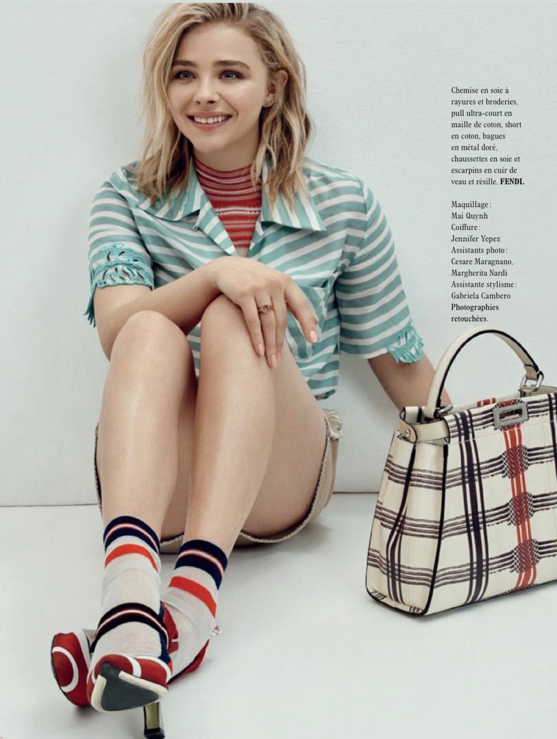 Flashing a smile, Chloe Grace Moretz wears Fendi shirt, sweater, shorts and sandals