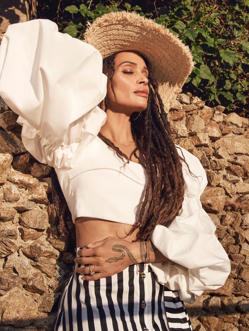 Soaking up the sun, Lisa Bonet wears Ellery blouse, Caroline Constas skirt and Miu Miu hat