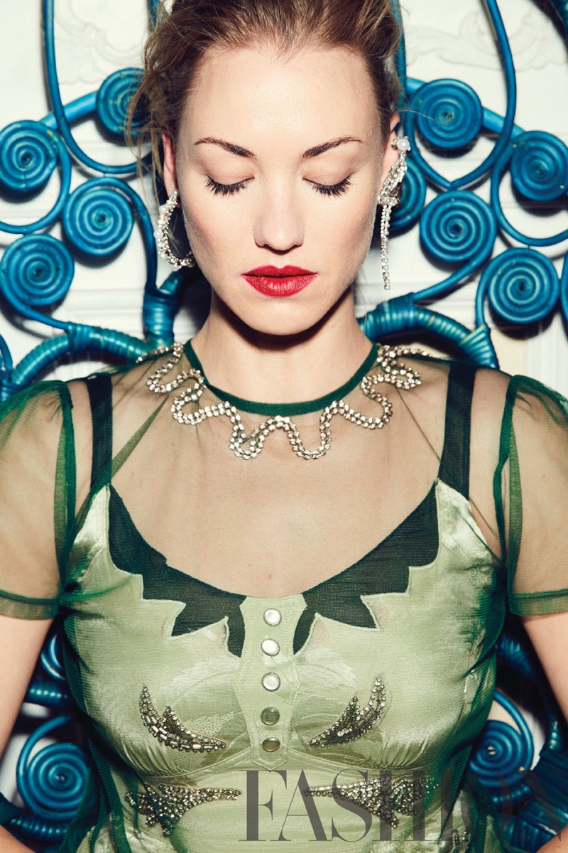 Actress Yvonne Strahovski poses in green Coach top and dress with Erickson Beamon earrings