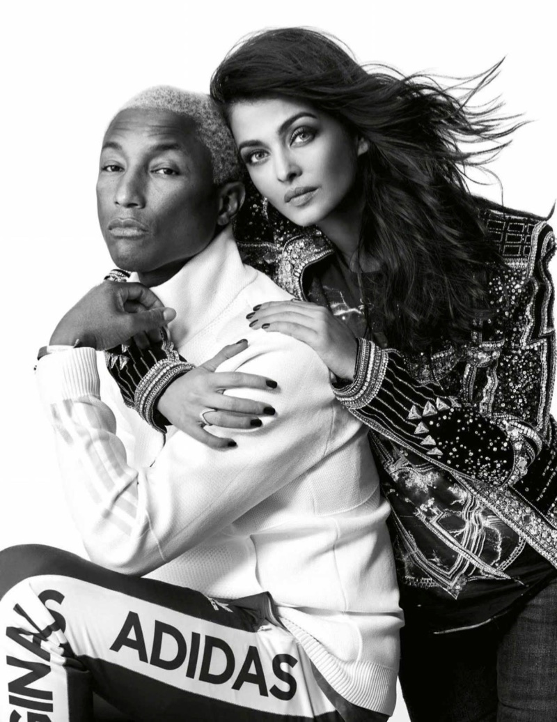 Photographed in black and white, Aishwarya Rai wears Balmain t-shirt and jacket with Zara jeans alongside Pharrell Williams