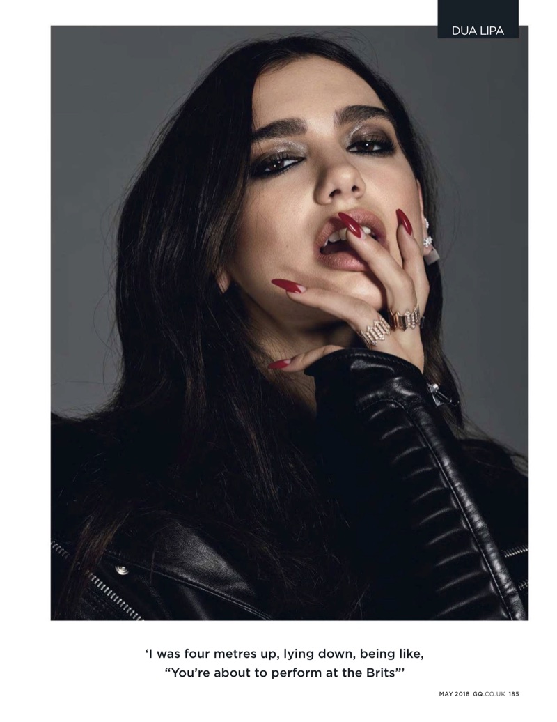 Showing off her manicure, Dua Lipa wears Philipp Plein jacket and and Maria Tash earring