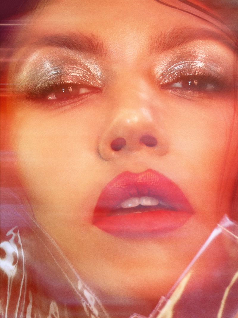 Ready for her closeup, Kourtney Kardashian wears glittery eyeshadow and red lip color
