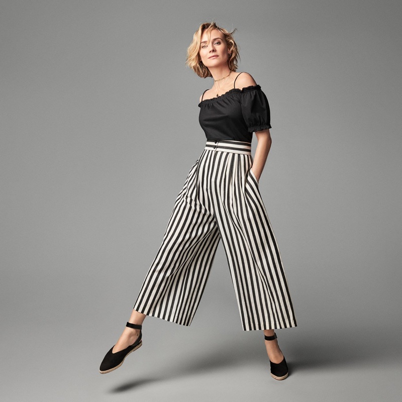 Actress Diane Kruger poses in H&M off-the-shoulder top, striped pants and flats