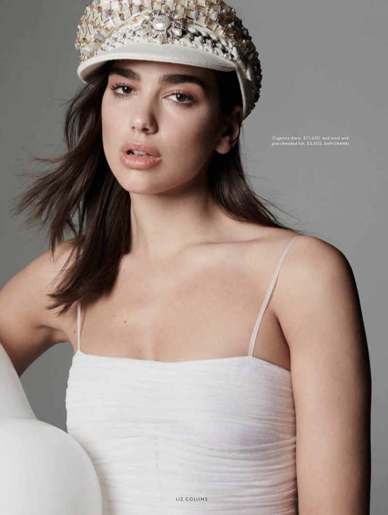 Singer Dua Lipa poses in Chanel dress and embellished hat