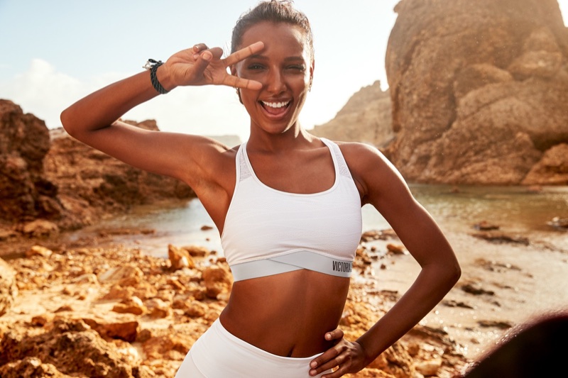 Showing off a piece sign, Jasmine Tookes poses for Victoria Sport