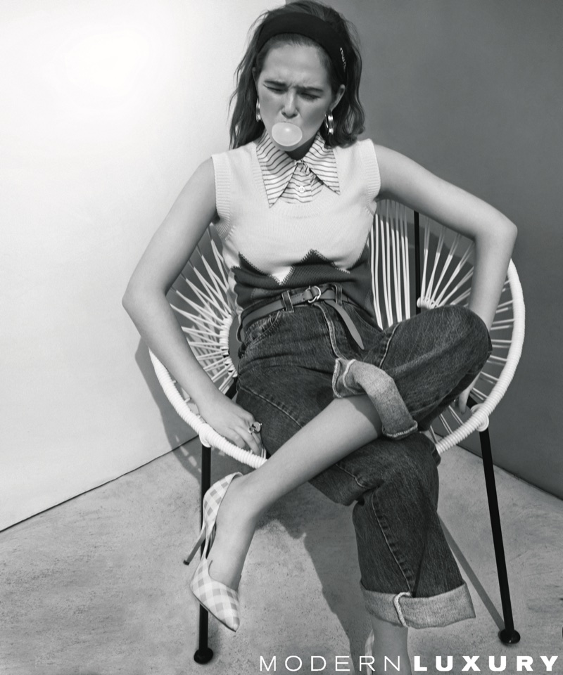 Photographed in black and white, Zoey Deutch poses in a chic outfit