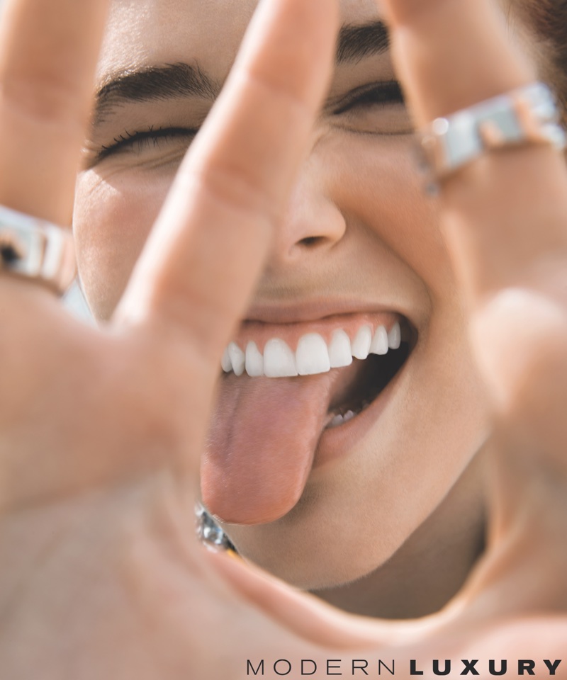 Sticking out her tongue, Zoey Deutch wears Jennifer Fisher ring and APM Monaco ring